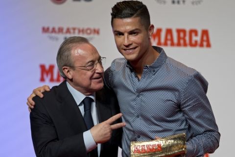 Juventus soccer player Cristiano Ronaldo poses next to Real Madrid's President Florentino Perez after receiving the Lifetime Achievement award by the Spanish sports paper 'Marca', in Madrid, Spain, Monday, July 29, 2019. (AP Photo/Paul White)