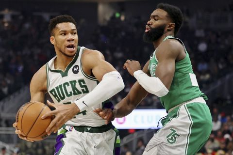 Milwaukee Bucks forward Giannis Antetokounmpo (34) drives to the basket against Boston Celtics guard Jaylen Brown (7) during the first half of an NBA basketball game Saturday, Dec. 25, 2021, in Milwaukee. (AP Photo/Jon Durr)