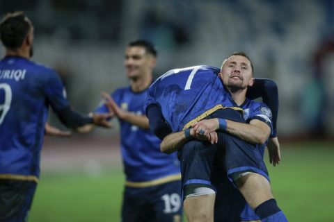 Kosovo's Bernard Berisha lifts his teammate Milot Rashica as they celebrate the opening goal during the Euro 2024 group I qualifying soccer match between Kosovo and Israel at the Fadil Vokrri stadium in Pristina, Kosovo, Sunday, Nov. 12, 2023. (AP Photo/Visar Kryeziu)