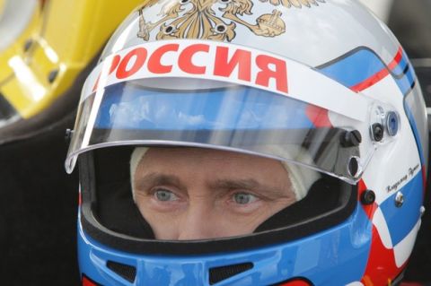 Russia's Prime Minister Vladimir Putin sits in a car of the Renault Formula One team as he test drives it at a racing track in Leningrad Region, November 7, 2010.  REUTERS/Ria Novosti/Pool/Alexei Druzhinin (RUSSIA - Tags: SPORT MOTOR RACING POLITICS) THIS IMAGE HAS BEEN SUPPLIED BY A THIRD PARTY. IT IS DISTRIBUTED, EXACTLY AS RECEIVED BY REUTERS, AS A SERVICE TO CLIENTS