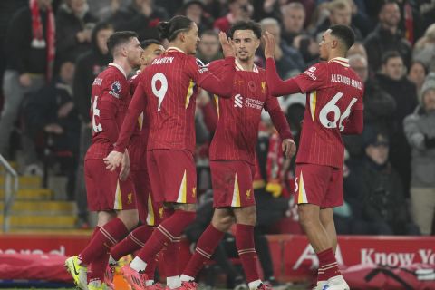 Liverpool's Darwin Nunez (9) celebrates with his teammates after scoring the opening goal against Aston Villa during the English Premier League soccer match at the Anfield stadium in Liverpool, Saturday, Nov. 9, 2024. (AP Photo/Jon Super)