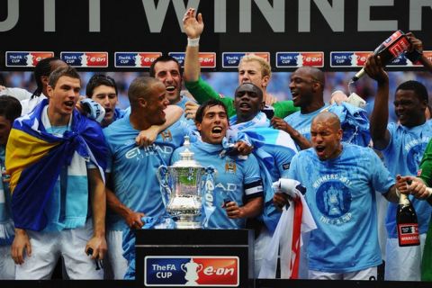 LONDON, ENGLAND - MAY 14:  Carlos Tevez (C) celebrates with his Manchester City team mates as they win the FA Cup sponsored by E.ON Final match between Manchester City and Stoke City at Wembley Stadium on May 14, 2011 in London, England.  (Photo by Mike Hewitt/Getty Images)