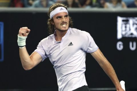 Stefanos Tsitsipas of Greece reacts after defeating Italy's Salvatore Caruso in their first round singles match at the Australian Open tennis championship in Melbourne, Australia, Monday, Jan. 20, 2020. (AP Photo/Dita Alangkara)