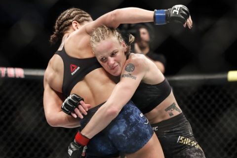 Valentina Shevchenko, right, tries to take down Jessica Eye during their women's flyweight title mixed martial arts bout at UFC 238, Saturday, June 8, 2019, in Chicago. (AP Photo/Kamil Krzaczynski)