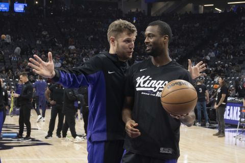 Sacramento Kings forward Sasha Vezenkov, left, and teammate Sacramento Kings forward Harrison Barnes enjoy a moment before an NBA basketball game against the Phoenix Suns in Sacramento, Calif., Friday, Dec. 22, 2023. (AP Photo/José Luis Villegas)