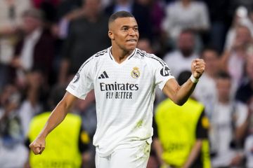 Real Madrid's Kylian Mbappe celebrates after scoring the opening goal during the Champions League opening phase soccer match between Real Madrid and VfB Stuttgart at the Santiago Bernabeu stadium, in Madrid, Tuesday, Sept. 17, 2024. (AP Photo/Manu Fernandez)