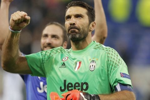 Juventus goalkeeper Gianluigi Buffon clenches his fist after the Champions League Group H soccer match against Lyon, Tuesday Oct. 18, 2016, in Lyon, central France. Juventus won 1-0. (AP Photo/Laurent Cipriani)