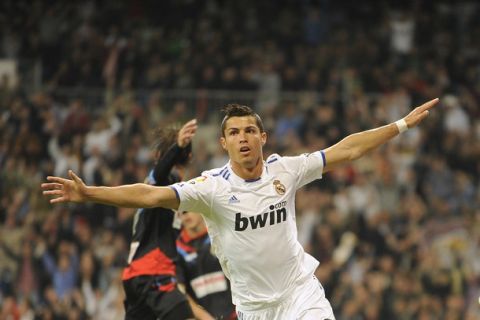 Real Madrid's Portuguese forward Cristiano Ronaldo celebrates his scoring against Racing de Santander during their Spanish league football match Real Madrid vs Racing de Santander at the Santiago Bernabeu Stadium, on October 23, 2010 in Madrid.   AFP PHOTO/ PEDRO ARMESTRE (Photo credit should read PEDRO ARMESTRE/AFP/Getty Images)