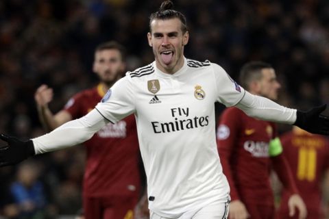 Real midfielder Gareth Bale celebrates after scoring his side's opening goal during a Champions League, Group G soccer match between Roma and Real Madrid at the Rome Olympic stadium, Tuesday, Nov. 27, 2018. (AP Photo/Gregorio Borgia)