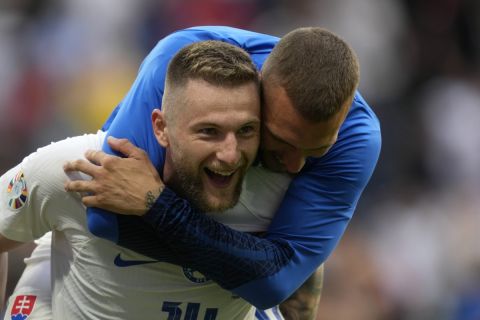 Slovakia's Milan Skriniar, left, celebrates after a Group E match between Belgium and Slovakia at the Euro 2024 soccer tournament in Frankfurt, Germany, Monday, June 17, 2024. Slovakia won 1-0. (AP Photo/Michael Probst)