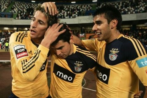 Benfica's Javier Saviola, center, from Argentina, celebrates  with teammates Fabio Coentrao, left, and Salvio, also from Argentina, after scoring the opening goal during their Portuguese league soccer match with Leiria at the Magalhaes Pessoa stadium on Sunday, Jan. 9, 2011 in Leiria, center Portugal. (AP Photo/ Francisco Seco)