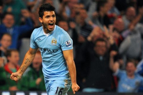 Manchester City's Argentinian forward Sergio Aguero celebrates after scoring during the English Premier League football match between Manchester City and Swansea at The Etihad stadium in Manchester,  north-west England on August 15 2011. AFP PHOTO/ANDREW YATES
RESTRICTED TO EDITORIAL USE. No use with unauthorized audio, video, data, fixture lists, club/league logos or live services. Online in-match use limited to 45 images, no video emulation. No use in betting, games or single club/league/player publications. (Photo credit should read ANDREW YATES/AFP/Getty Images)