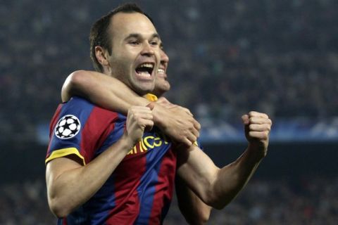 Barcelona's Andres Iniesta (L) celebrates his goal against Shakhtar Donetsk during the first leg of their Champions League quarter-final soccer match at Camp Nou stadium in Barcelona, in this April 6, 2011 file photo. Barcelona on April 19, 2011 have decided to appeal UEFA's proposal to ban Iniesta for one Champions League match for deliberately collecting a yellow card. UEFA officials at the match alleged Iniesta provoked the card so he could serve the standard one-match ban in the second leg and would have a clean slate for the semi-finals.        REUTERS/Albert Gea/Files    (SPAIN - Tags: SPORT SOCCER)