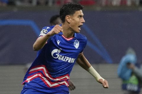 Red Star's Marko Stamenic celebrates after scoring his side's opening goal during the group G Champions League soccer match between RB Leipzig and Red Star Belgrade at the Red Bull arena stadium in Leipzig, Germany, Wednesday, Oct. 25, 2023. (AP Photo/Matthias Schrader)