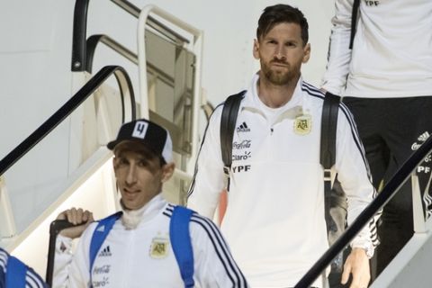 Lionel Messi, center right, and Angel Di Maria, center left, step out of the plane as Argentina national soccer team arrive at Zhukovsky international airport outside Moscow, Russia, Saturday, June 9, 2018 to compete in the 2018 World Cup in Russia. The 21st World Cup begins on Thursday, June 14, 2018, when host Russia takes on Saudi Arabia. (AP Photo/Pavel Golovkin)