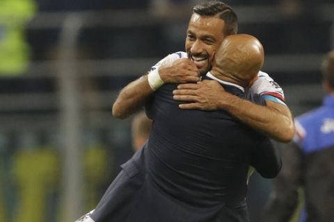 Inter Milan coach Luciano Spalletti embraces Sampdoria's Fabio Quagliarella after beating Sampdoria 3 - 2 in an Italian Serie A soccer match between Inter Milan and Sampdoria, at the San Siro stadium in Milan, Italy, Tuesday, Oct. 24, 2017. (AP Photo/Luca Bruno)