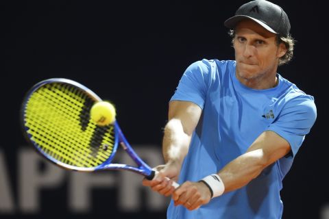 Uruguay's Diego Forlan returns the ball to Boris Arias and Federico Zeballos during a men's doubles tennis match at the 2024 Uruguay Open in Montevideo, Uruguay, Wednesday, Nov. 13, 2024. (AP Photo/Matilde Campodonico)