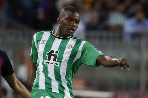 Betis' William Carvalho, right, passes the ball past Barcelona's Pedri during a Spanish La Liga soccer match between Barcelona and Real Betis at the Camp Nou stadium in Barcelona, Spain, Saturday, April 29, 2023. (AP Photo/Joan Monfort)