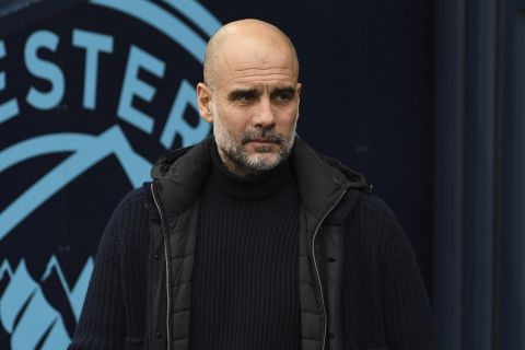 Manchester City's head coach Pep Guardiola arrives to the pitch prior to the English Premier League soccer match between Manchester City and Everton at the Etihad stadium in Manchester, Thursday, Dec. 26, 2024. (AP Photo/Rui Vieira)