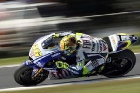 Valentino Rossi of Italy, Fiat Yamaha Team, controls his bike during the first practice session of the MotoGP at the Australian Grand Prix motorcycle racing on Phillip Island, Australia, Friday, Oct. 16, 2009. Valentino Rossi of Italy, Fiat Yamaha Team clocked the fastest times ahead of, Casey Stoner of Australia, Ducati Marlboro Team, and Dani Pedrosa of Spain, Repsol Honda Team. (AP Photo/Rob Griffith)