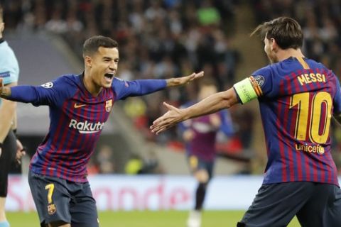 Barcelona forward Philippe Coutinho, left, celebrates with Barcelona forward Lionel Messi, right, after scoring his sides first goal during the Champions League Group B soccer match between Tottenham Hotspur and Barcelona at Wembley Stadium in London, Wednesday, Oct. 3, 2018. (AP Photo/Frank Augstein)