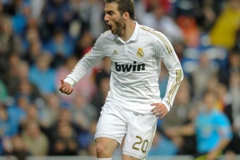 Real Madrid's Argentinian forward Gonzalo Higuain celebrates scoring during the Spanish League football match Real Madrid against Sporting of Gijón, at the Santiago Bernabeu stadium in Madrid, on April 14, 2012. AFP PHOTO/Pedro ARMESTRE. (Photo credit should read PEDRO ARMESTRE/AFP/Getty Images)