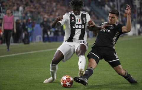 Juventus' Moise Kean, left, and Ajax's Lisandro Magallan fight for the ball during the Champions League quarter final, second leg soccer match between Juventus and Ajax, at the Allianz stadium in Turin, Italy, Tuesday, April 16, 2019. (AP Photo/Antonio Calanni)