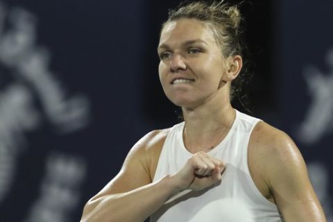 Romania's Simona Halep celebrates after she beats Kazakhstan's Elena Rybakina in the final match of the Dubai Duty Free Tennis Championship in Dubai, United Arab Emirates, Saturday, Feb. 22, 2020. (AP Photo/Kamran Jebreili)