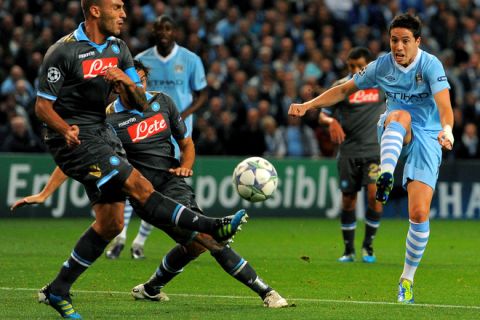 Manchester City's French midfielder Samir Nasri (R) shoots during the UEFA Champions league group A football match between Manchester City and Napoli at the Etihad stadium in Manchester, north-west England, on September 14, 2011. AFP PHOTO/ANDREW YATES (Photo credit should read ANDREW YATES/AFP/Getty Images)