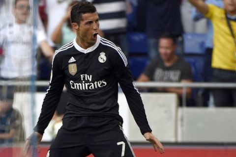 Real Madrid's Portuguese forward Cristiano Ronaldo celebrates a goal during the Spanish league football match RCD Espanyol vs Real Madrid CF at the Cornella-El Prat stadium in Cornella de Llobregat on May 17, 2015.   AFP PHOTO / LLUIS GENE
