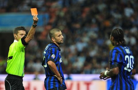 Italian referee Gianluca Rocchi (L) shows a red card to Inter Milan's Nigerian midfielder Joel Obi (R) during the Italian serie A football match Inter Milan vs Napoli, at San Siro stadium in Milan on October 1, 2011. Inter Milan coach Claudio Ranieri blasted referee Gianluca Rocchi after his team were beaten 3-0 at home by Napoli in a match they finished with 10 men. Inter had Joel Obi sent off in the first half for a second yellow card while Ranieri himself also saw red after raging at the referee at the break. Television replays showed Obi's first yellow was given for a good tackle while his second, which resulted in a penalty, was for a foul that happened outside the box.   AFP PHOTO/ ALBERTO PIZZOLI (Photo credit should read ALBERTO PIZZOLI/AFP/Getty Images)