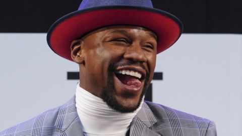 Floyd Mayweather Jr. smiles as Japanese kickboxer Tenshin Nasukawa speaks after their official weigh-in ceremony during a news conference in Saitama, north of Tokyo Sunday, Dec. 30, 2018. Mayweather is scheduled to fight in a three-round exhibition match in Japan on New Year's Eve. (AP Photo/Eugene Hoshiko)