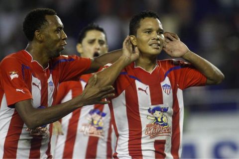 Carlos Bacca (R) of Colombia's Junior de Barranquilla celebrates after scoring against Bolivia's Oriente Petrolero during their Copa Libertadores 2011 football match at the Roberto Melendez stadium in Barranquilla, Colombia, on March 17, 2011. AFP PHOTO/STR (Photo credit should read STR/AFP/Getty Images)