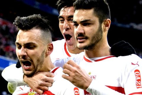 Stuttgart's Anastasios Donis, left, celebrates his side's equalizing goal with team mates during a German Bundesliga soccer match between Bayern Munichand VfB Stuttgart in Munich, Sunday, Jan.27, 2019. (Matthias Balk/dpa via AP)