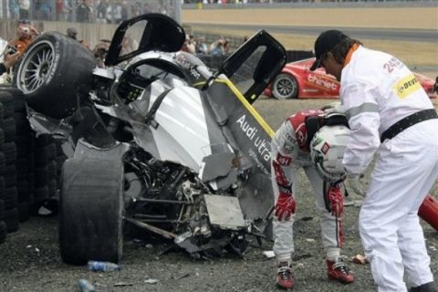 Driver Allan McNish of Scotland after crashing  in Audi No 3 after the crash during the 79th 24-hour Le Mans endurance race, in Le Mans, western France, Saturday, June 11, 2011. Audi kept the lead after the first pit stops at the 24 Hours of Le Mans but lost a car when Allan McNish's Audi No. 3 collided with a Ferrari on Saturday afternoon. (AP Photo/Vincent Michel)