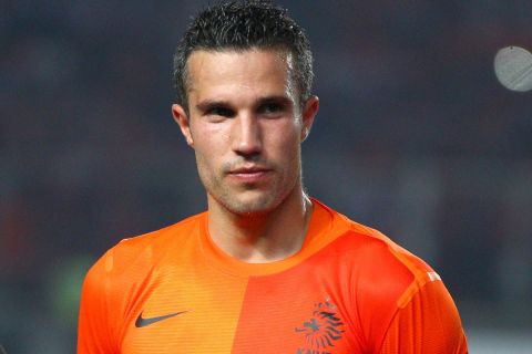 Robin van Persie of the Netherlands listens to the national anthems before his friendly soccer match against Indonesia at Gelora Bung Karno stadium in Jakarta, Indonesia, Friday, June 7, 2013. (AP Photo/Dita Alangkara)