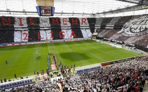 Supporters of Eintracht Frankfurt present a huge choreography reading "never ever second division again" prior to their German second division Bundesliga soccer match against TSV 1860 Munich in Frankfurt April 29, 2012. Frankfurt was already promoted into the first division Bundesliga.     REUTERS/Kai Pfaffenbach (GERMANY - Tags: SPORT SOCCER) DFL LIMITS USE OF IMAGES ON THE INTERNET TO 15 PICTURES DURING THE MATCH AND, PROHIBITS MOBILE (MMS) USE DURING AND UP TO 2 HOURS POST MATCH. FOR MORE INFORMATION CONTACT DFL