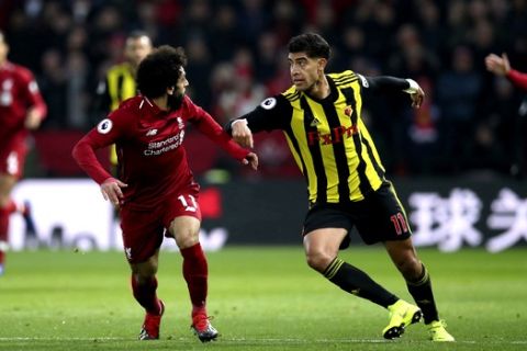 Liverpool's Mohamed Salah, left, and Watford's Adam Masina battle for the ball during their English Premier League soccer match at The London Stadium, London, Saturday, Nov 24, 2018. (Dominic Lipinski/PA via AP)