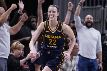 Indiana Fever guard Caitlin Clark (22) smiles after gabbing her tenth rebound in the closing seconds of a games against the Los Angeles Sparks in the second half of a WNBA basketball game in Indianapolis, Wednesday, Sept. 4, 2024. The rebound gave Clark a triple-double for the game. (AP Photo/Michael Conroy)