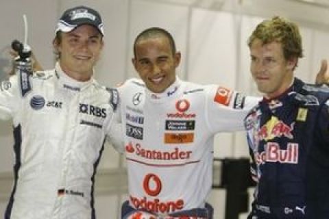 McLaren Formula One driver Lewis Hamilton, centre, reacts after qualifying in pole position for during the Singapore Grand Prix on the Marina Bay City Circuit in Singapore, Saturday, Sept 26, 2009. Red Bull's Sebastian Vettel, right, of Germany was second and compatriot, Williams driver Nico Rosberg, left, qualified third for tomorrows race.  (AP Photo/Mark Baker)