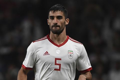 Iran's defender Milad Mohammadi runs with the ball during the AFC Asian Cup semifinal soccer match between Iran and Japan at Hazza Bin Zayed Stadium in Al Ain, United Arab Emirates, Monday, Jan. 28, 2015. (AP Photo/Hassan Ammar)