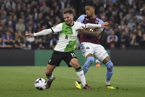 Liverpool's Alexis Mac Allister, left, challenges for the ball with Aston Villa's Ezri Konsa during the English Premier League soccer match between Aston Villa and Liverpool at the Villa Park stadium in Birmingham, England, Monday, May 13, 2024. (AP Photo/Rui Vieira)