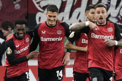 Leverkusen's Patrik Schick, center, celebrates after scoring the opening goal during the German Soccer Cup match between Bayer Leverkusen and SV Elversberg at the BayArena in Leverkusen, Germany, Tuesday, Oct. 29, 2024. (AP Photo/Martin Meissner)