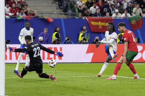 Eduardo Camavinga of France, 2nd right, attempts a shot at goal during a quarter final match between Portugal and France at the Euro 2024 soccer tournament in Hamburg, Germany, Friday, July 5, 2024. (AP Photo/Martin Meissner)