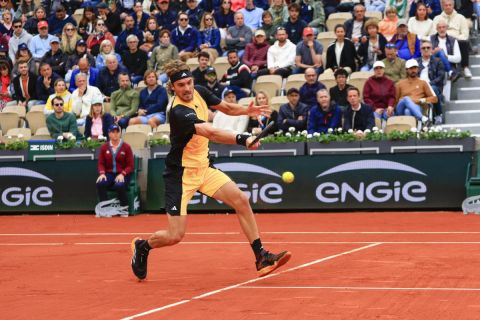 Greece's Stefanos Tsitsipas plays a shot against Hungary's Marton Fucsovics during their first round match of the French Open tennis tournament at the Roland Garros stadium in Paris, Monday, May 27, 2024. (AP Photo/Aurelien Morissard)