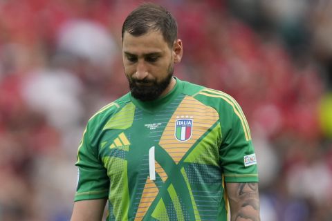 Italy's goalkeeper Gianluigi Donnarumma reacts after Switzerland's Ruben Vargas scored his side's second goal during a round of sixteen match between Switzerland and Italy at the Euro 2024 soccer tournament in Berlin, Germany, Saturday, June 29, 2024. (AP Photo/Ariel Schalit)