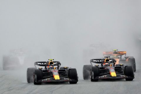 Red Bull driver Sergio Perez of Mexico, center, leads Red Bull driver Max Verstappen of the Netherlands, foreground right, into the first curve at the start of the sprint race ahead of Sunday's Formula One Austrian Grand Prix auto race, at the Red Bull Ring racetrack, in Spielberg, Austria, Saturday, July 1, 2023. (AP Photo/Darko Vojinovic)