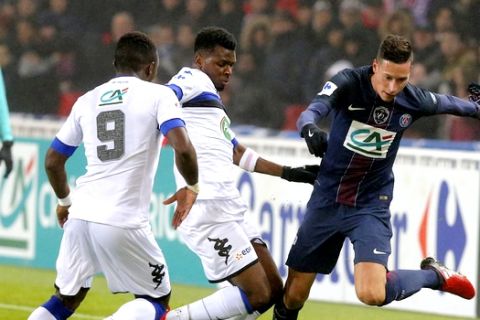 PSG's Julian Draxler, right, challenges for the ball with Bastia's Abdoulaye Keita, left, and Abdoulaye Sadio Diallo during a French Cup soccer match Paris Saint-Germain against Bastia at Parc des Princes stadium in Paris, Saturday, Dec. 7, 2017. (AP Photo/Michel Euler)