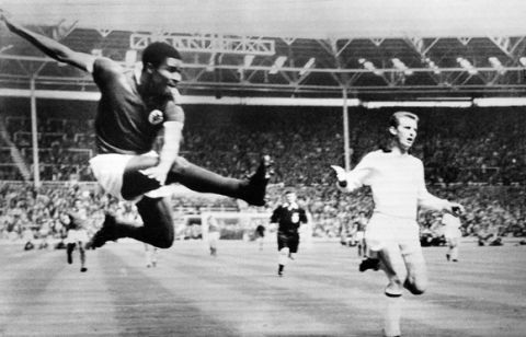 (FILES) -- A file handout picture taken on May 22, 1963 and released by Central Press shows Football legend and former Portugal's national team player Eusebio da Silva Ferreira (L) kicking the ball during a soccer match between Milan AC and Benfica for the European Cup in Wembley. Eusebio, who was the 1965 European Footballer of the Year and considered one of the best footballers of all time and best ever from Portugal, died at age 71 on January 5, 2014. AFP PHOTO / CENTRAL PRESS
RESTRICTED TO EDITORIAL USE - MANDATORY CREDIT "AFP PHOTO / CENTRAL PRESS" - NO MARKETING NO ADVERTISING CAMPAIGNS - DISTRIBUTED AS A SERVICE TO CLIENTS
