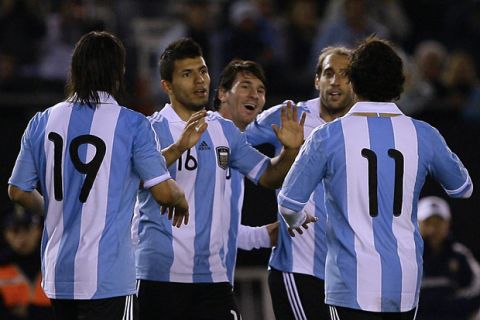 Argentina's forward Sergio Aguero (2-L) celebrates with teammates, forward Lionel Messi (C), midfielder Ever Banega (L), forward Carlos Tevez (R), and defender Pablo Zabaleta, after scoring the team's third goal against Albania's midfielder Franc Velih during a friendly football match at the Monumental stadium in Buenos Aires on June 20, 2011. Argentina won 4-0. AFP PHOTO / Maxi Failla (Photo credit should read Maxi Failla/AFP/Getty Images)